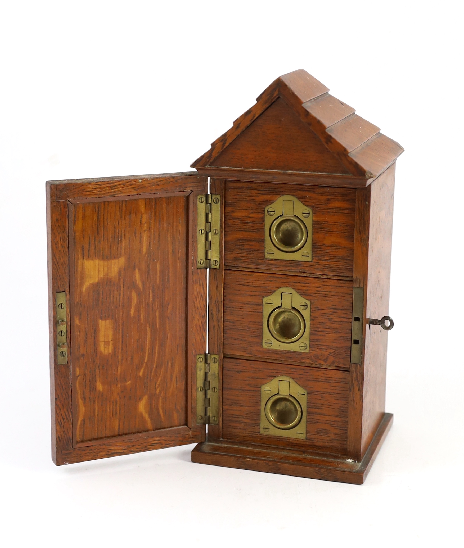 A late Victorian oak smoker’s cabinet modelled as a sentry box with a watercolour panel by Richard Simkin (1840-1926)